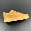 Suede low-top sneakers in tan/yellow with Nike swoosh and lace-up design