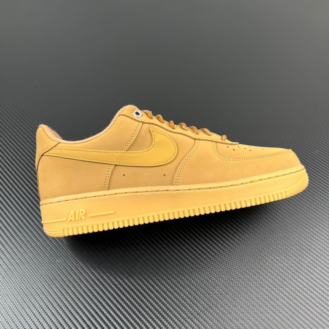 Suede low-top sneakers in tan/yellow with Nike swoosh and lace-up design