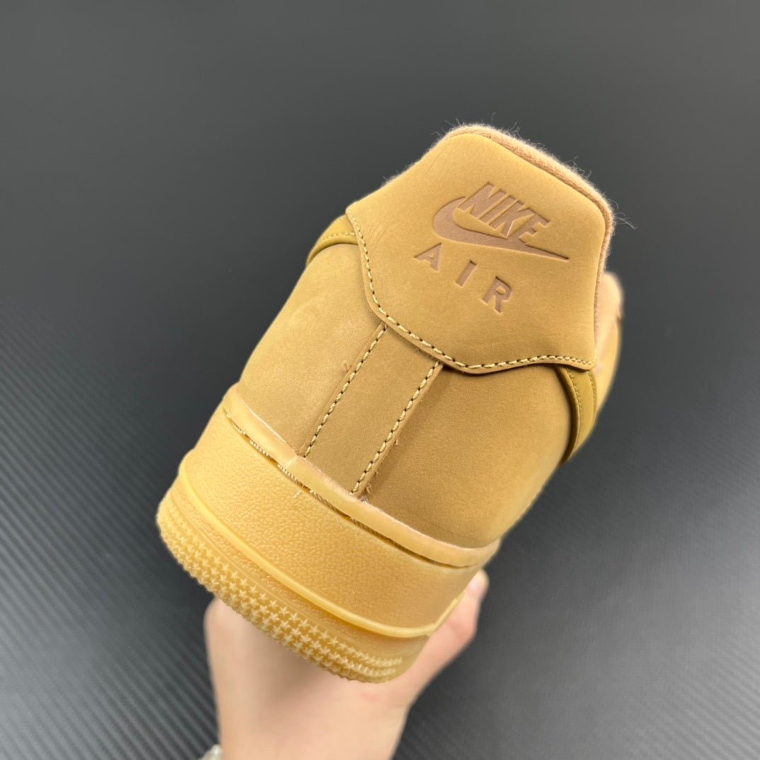 Tan/yellow suede sneaker heel with Nike Air logo patch