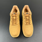 Pair of tan/yellow lace-up sneakers with perforations and Nike Air logo