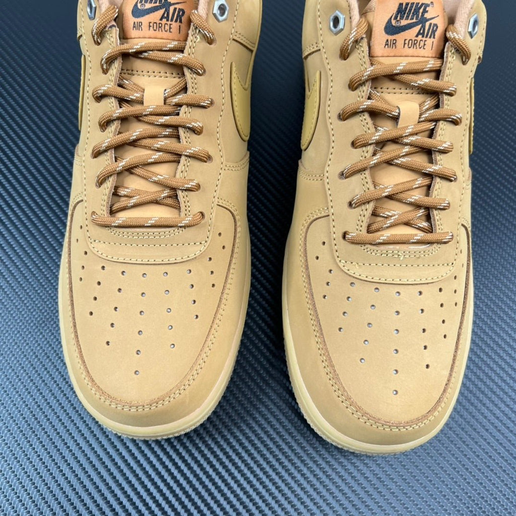 Two tan/yellow suede sneakers front view with lace-up and perforated toe