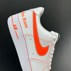 White low-top sneaker heel panel with orange trim and 'Air' text.