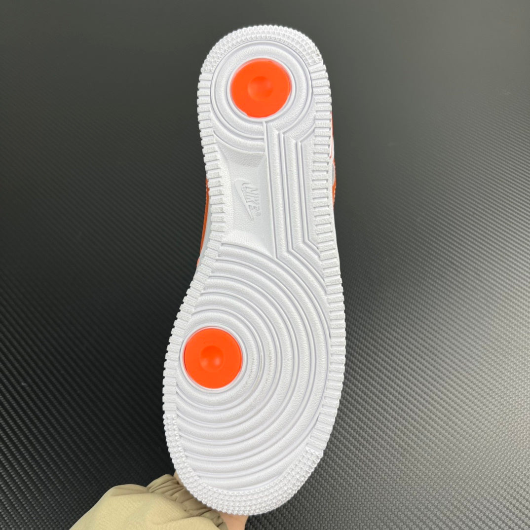 White rubber outsole with orange traction pods, sneaker bottom view.
