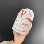 White low-top sneaker heel with orange Swoosh and 'Air' branding, side view.