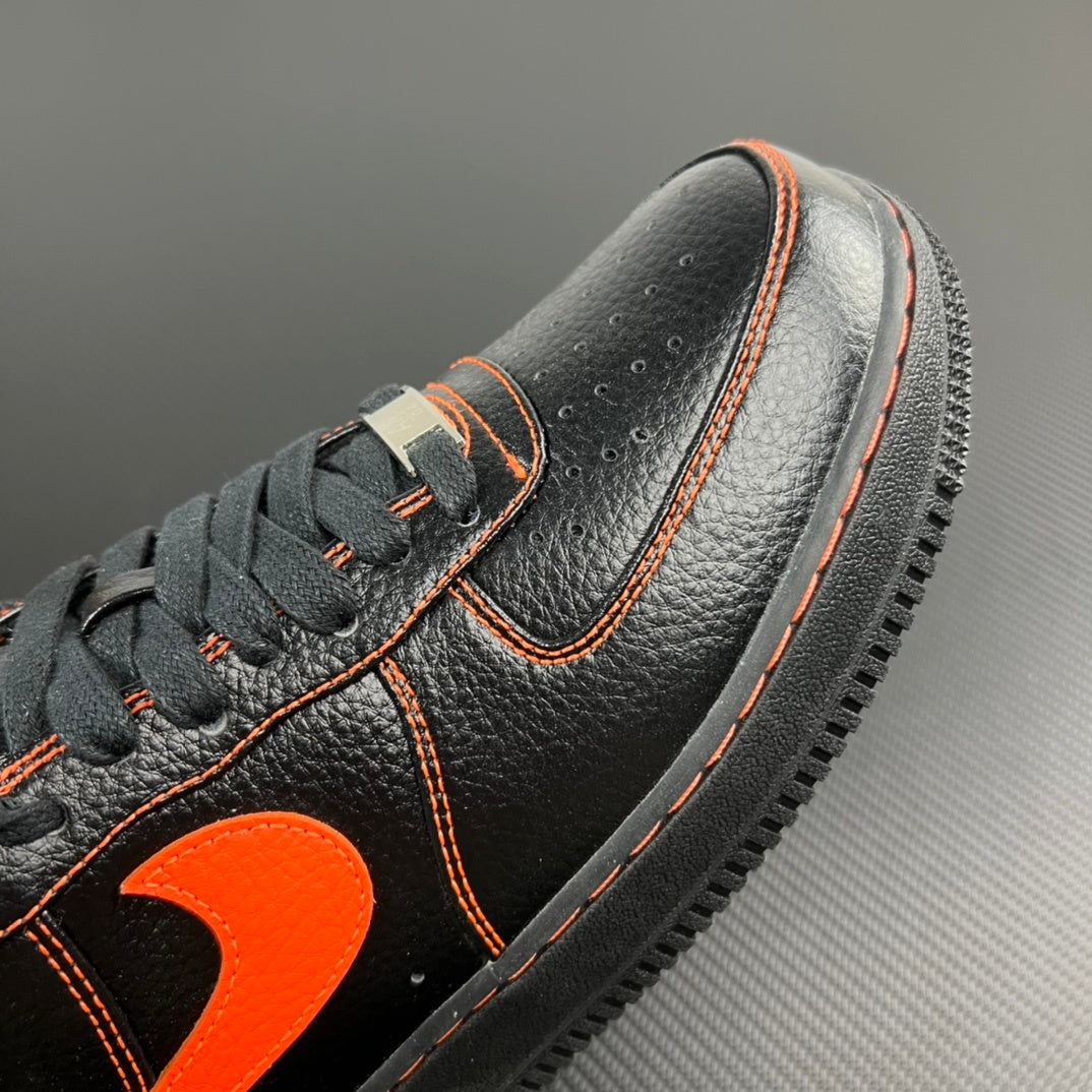Black leather Air Force 1 sneaker with orange piping and heel tab detail