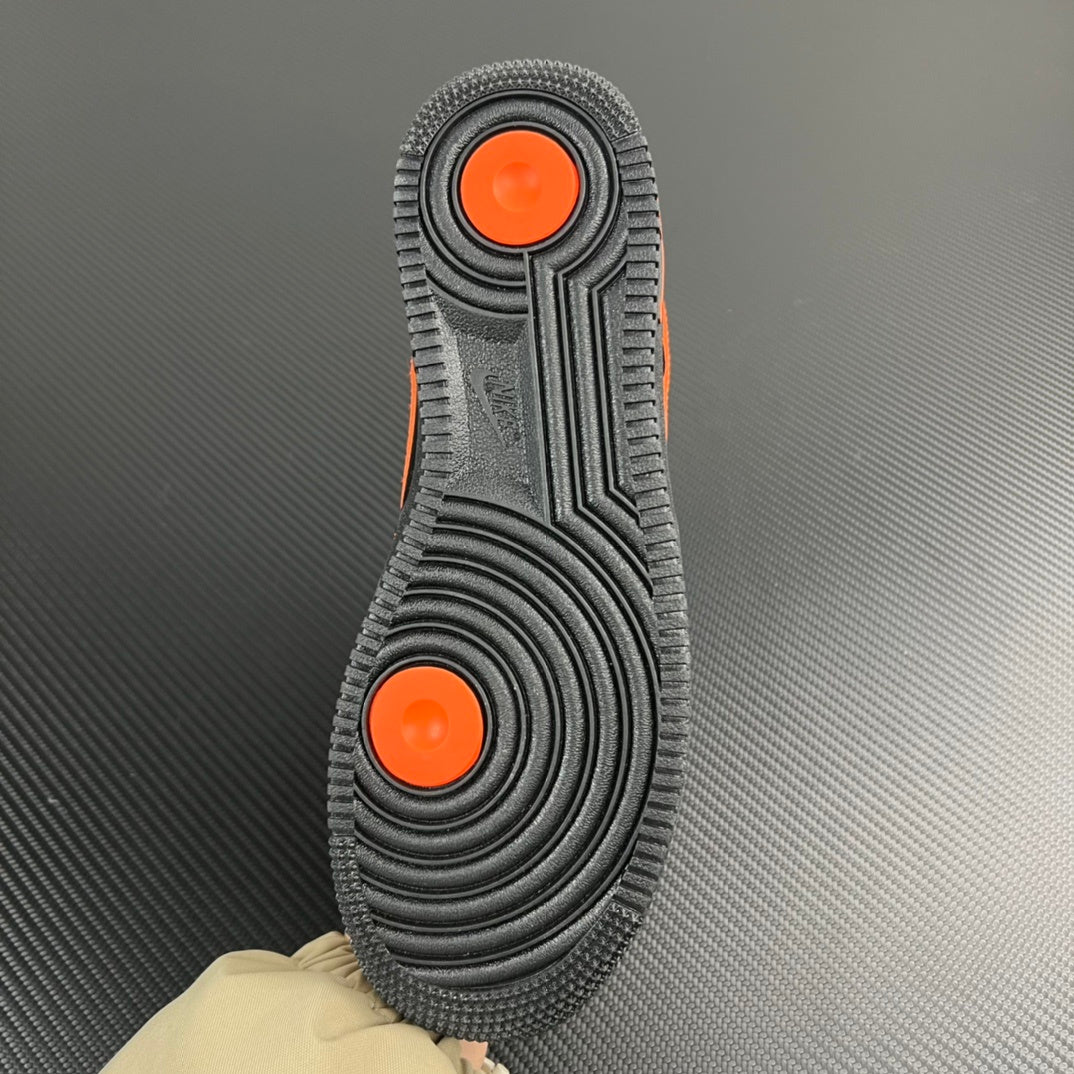 Black Air Force 1 outsole with two orange pods and concentric tread pattern