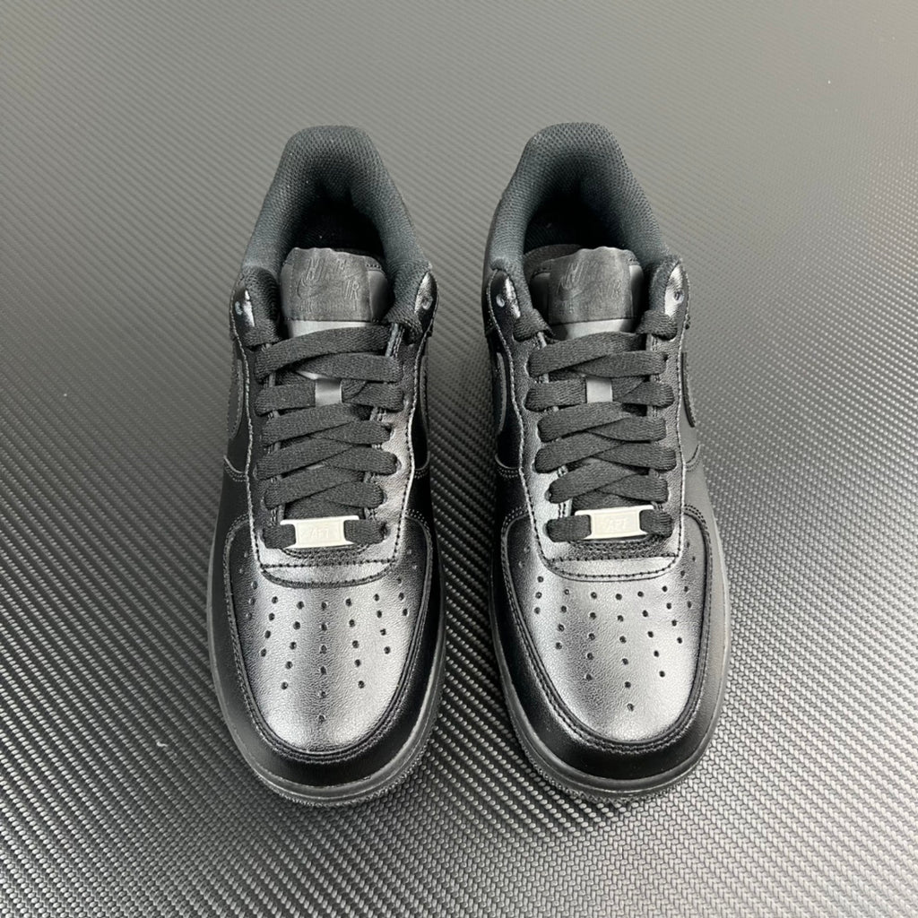 FRGMT Air Force 1 low-top sneaker pair, dark uppers with silver toe caps and lace panels
