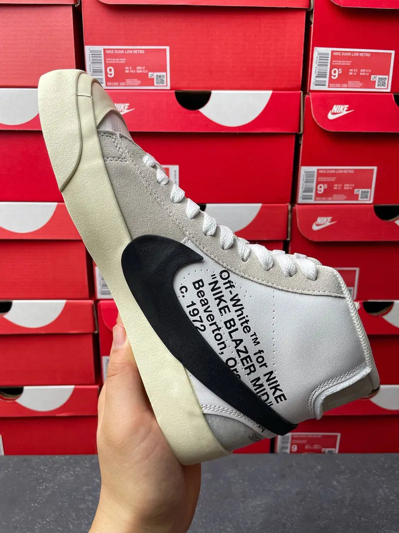 Off-white high-top sneaker showing black sockliner text on light grey upper