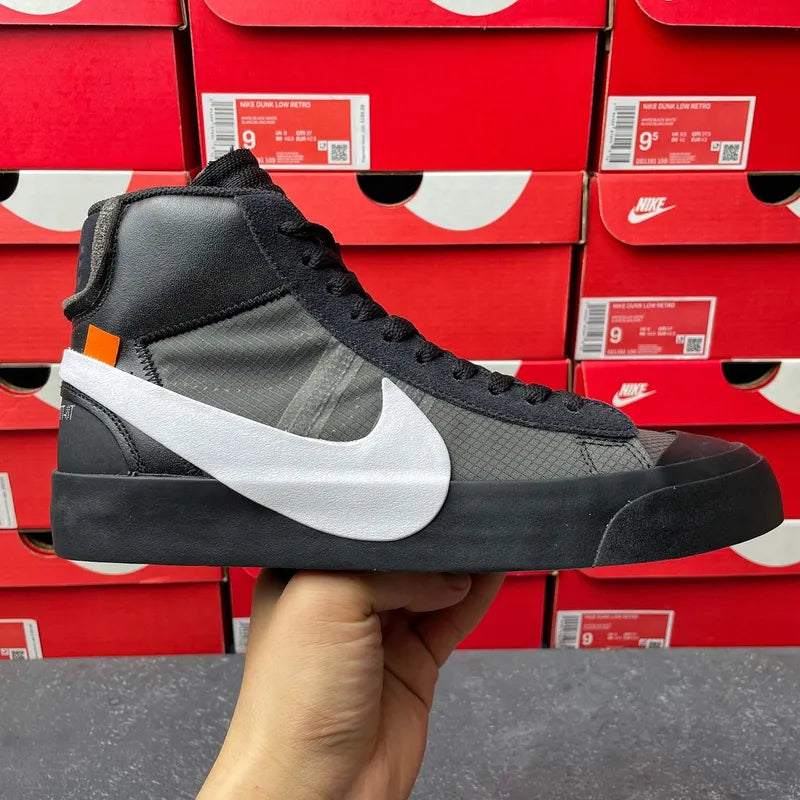 Black high-top Nike sneaker with white swoosh and black laces, held in hand