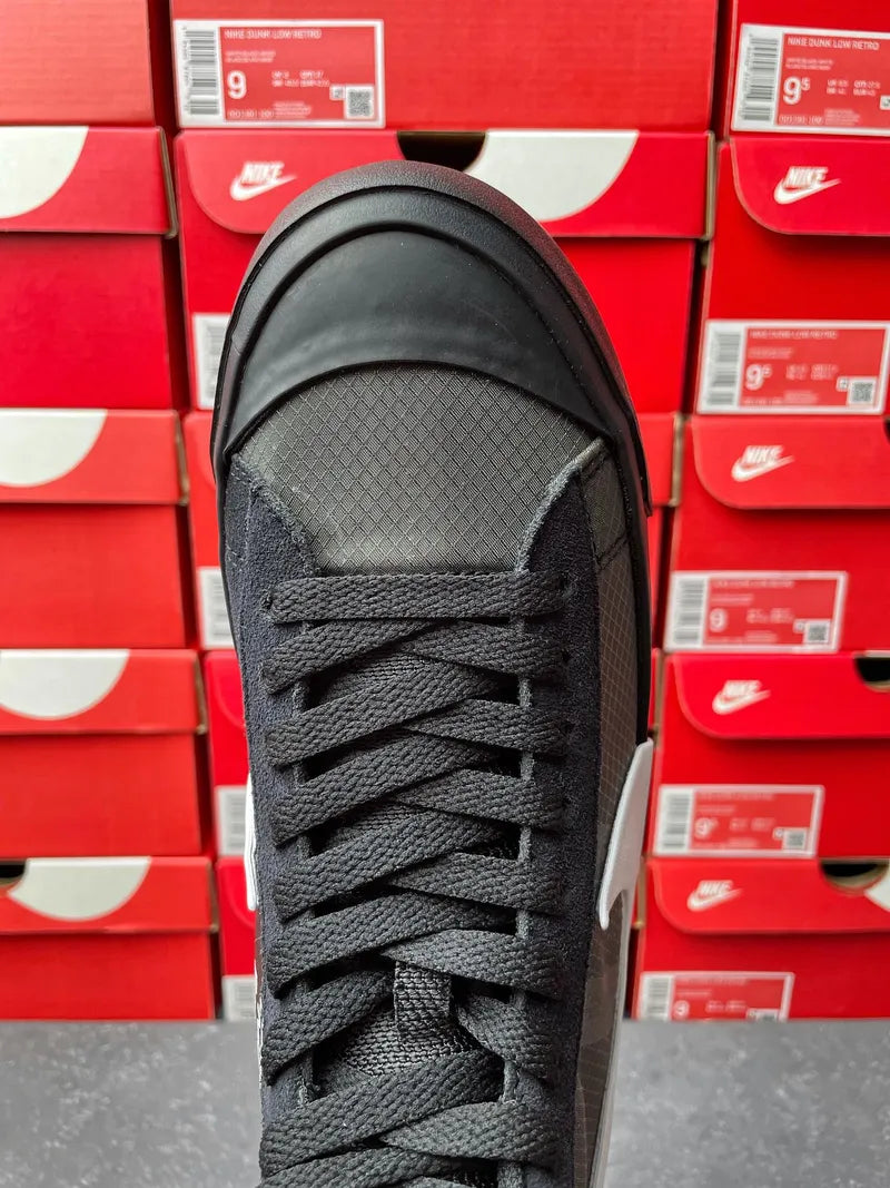 Black Nike high-top sneaker front view with laces, toe and tongue visible