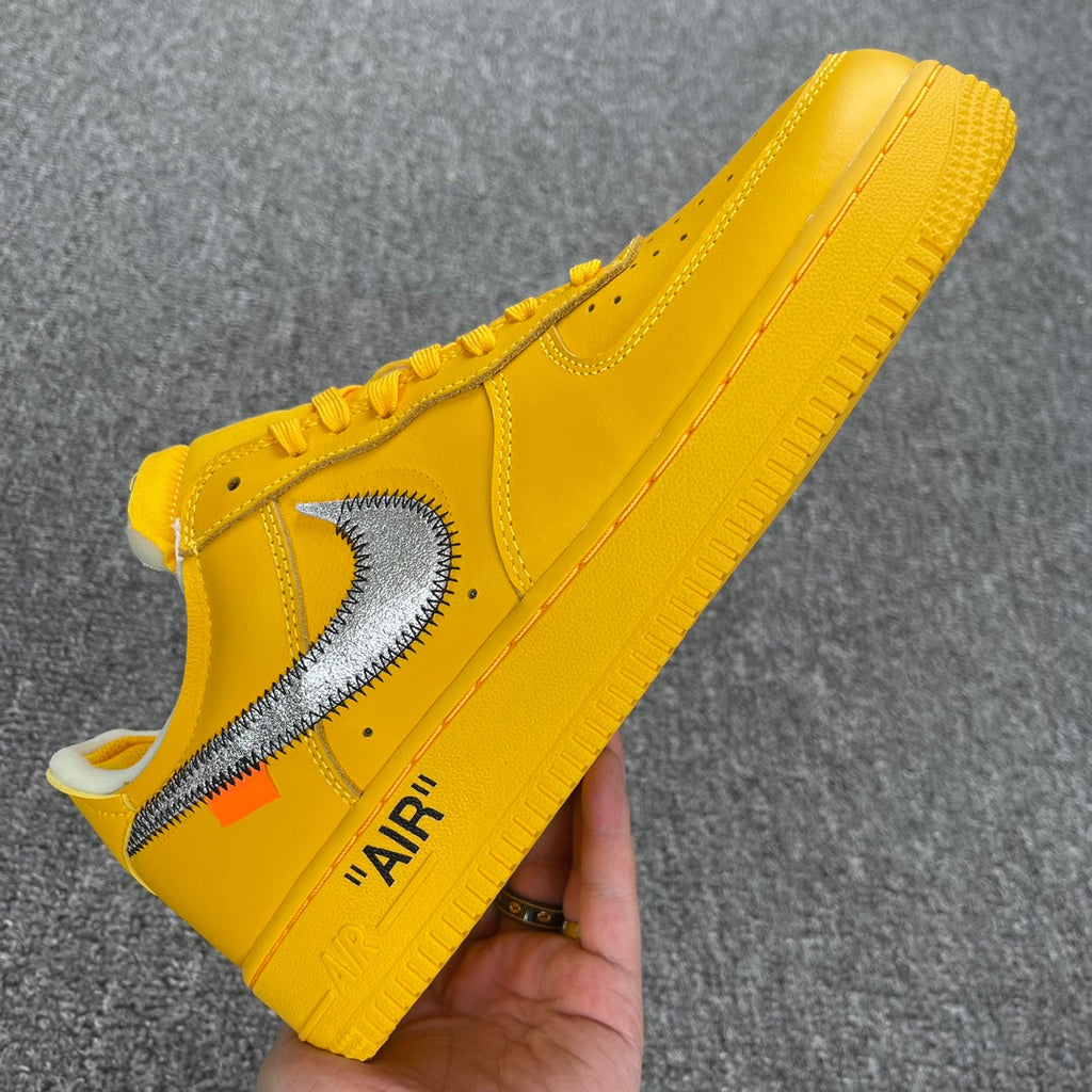 Yellow Air Force 1 sneaker side view with white swoosh and 'AIR' heel text