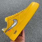 Yellow Air Force 1 sneaker side view with white swoosh and 'AIR' heel text
