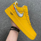 Yellow Air Force 1 sneaker with white swoosh and lace-up front, 'AIR' on heel