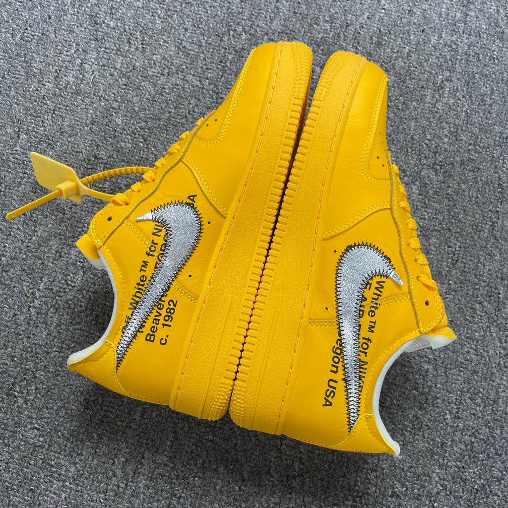Yellow Air Force 1 sneakers with text print on sides and white swooshes
