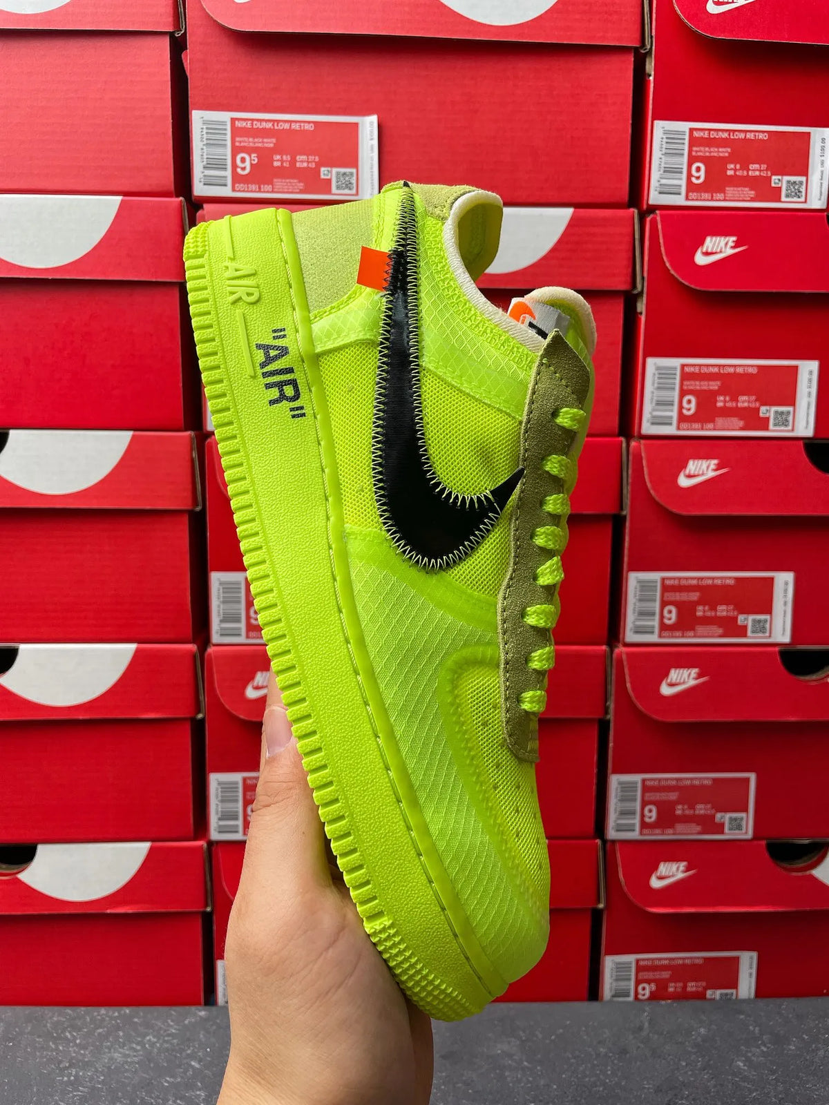 Neon green Nike sneaker side view with black swoosh and lime lace-up