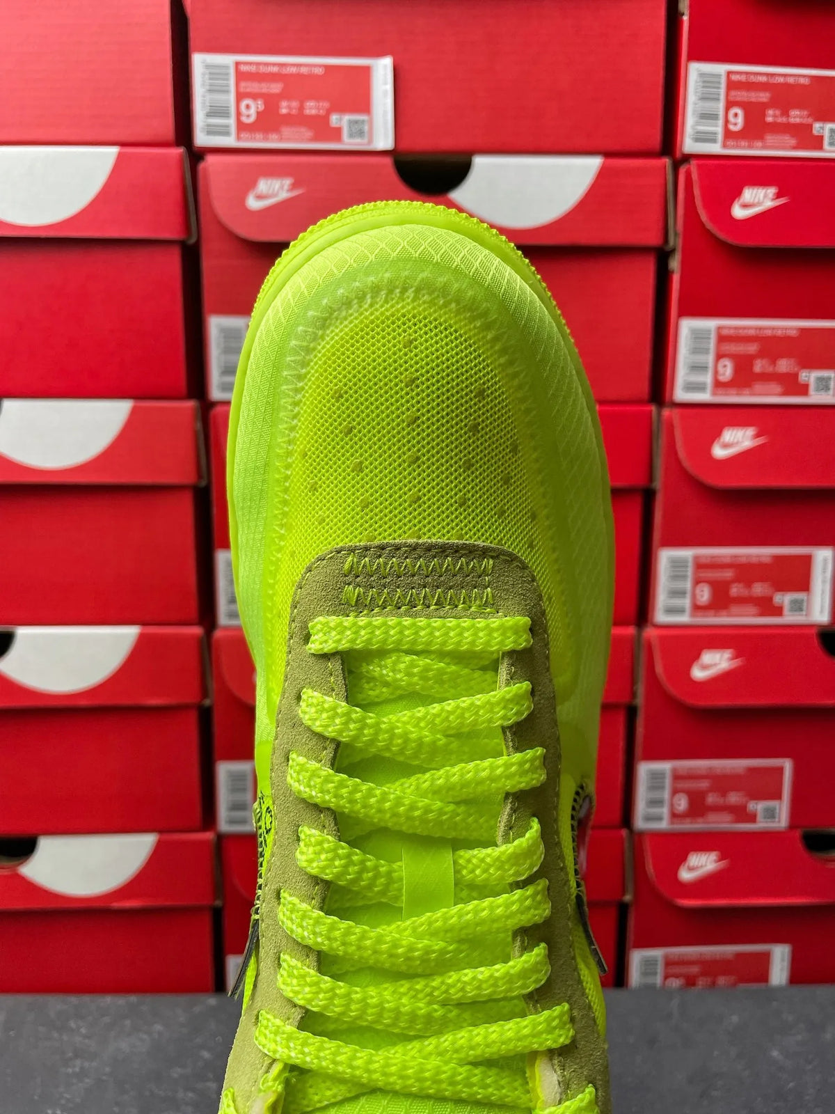 Neon green sneaker top view showing lace-up and side branding