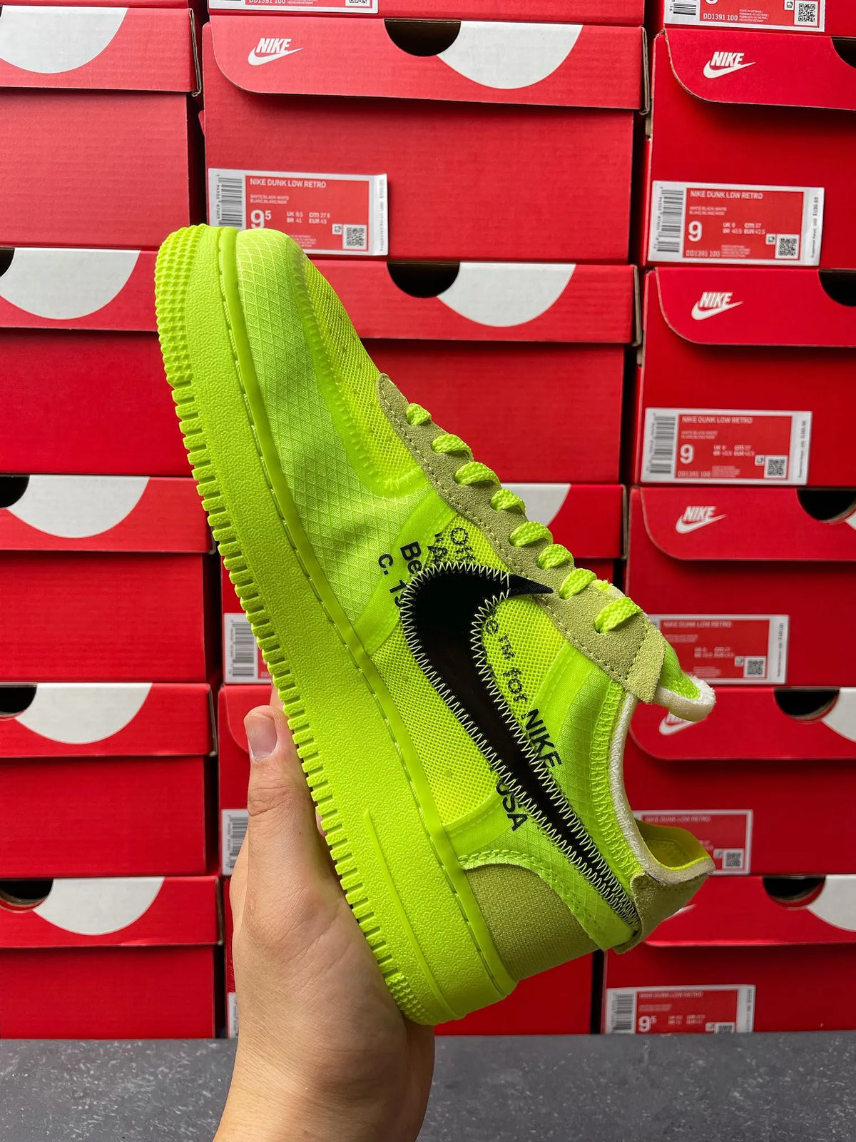 Neon green sneaker side view with black swoosh and text on eyestay panel
