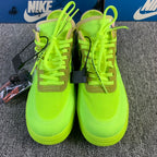 Neon green low-top sneakers pair with lace-up uppers and hanging accessory tag