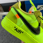 Neon green low-top sneaker with khaki lining and orange side accent