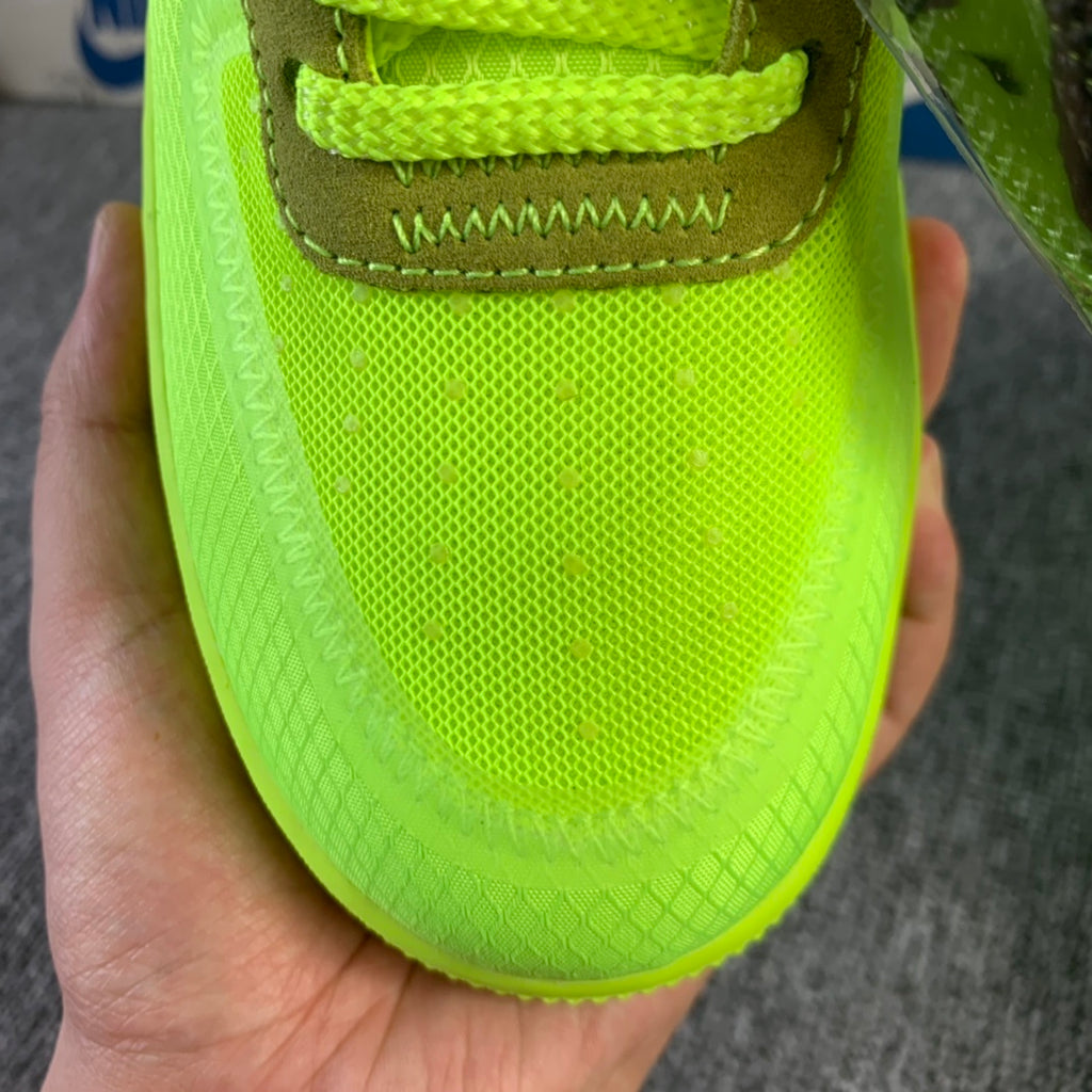 Neon green sneaker with textured sole and brown heel tab