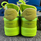 Neon green sneakers with suede heel lining and embossed heel text