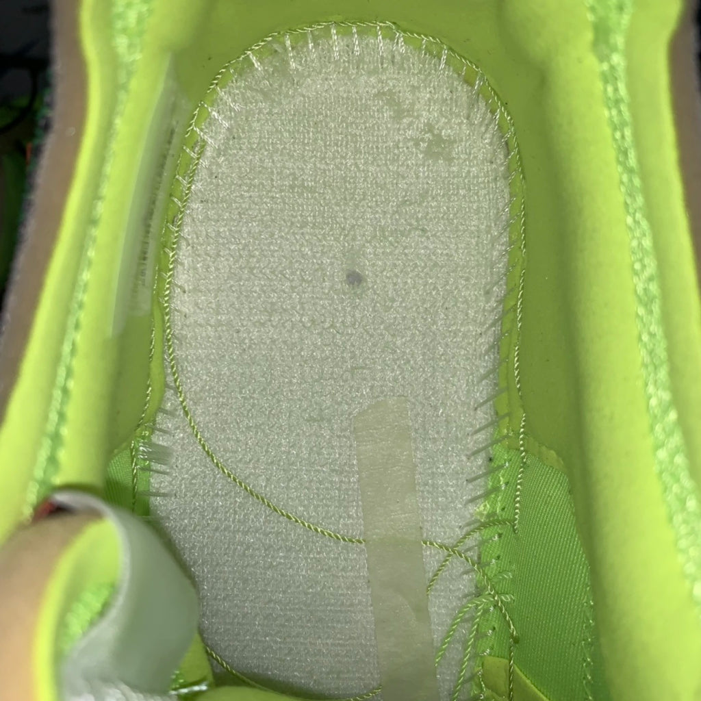 Neon green sneaker interior with gray cushioned insole surface