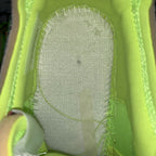 Neon green sneaker interior with gray cushioned insole surface