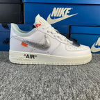 White low-top sneaker with silver swoosh and "AIR" text on the side