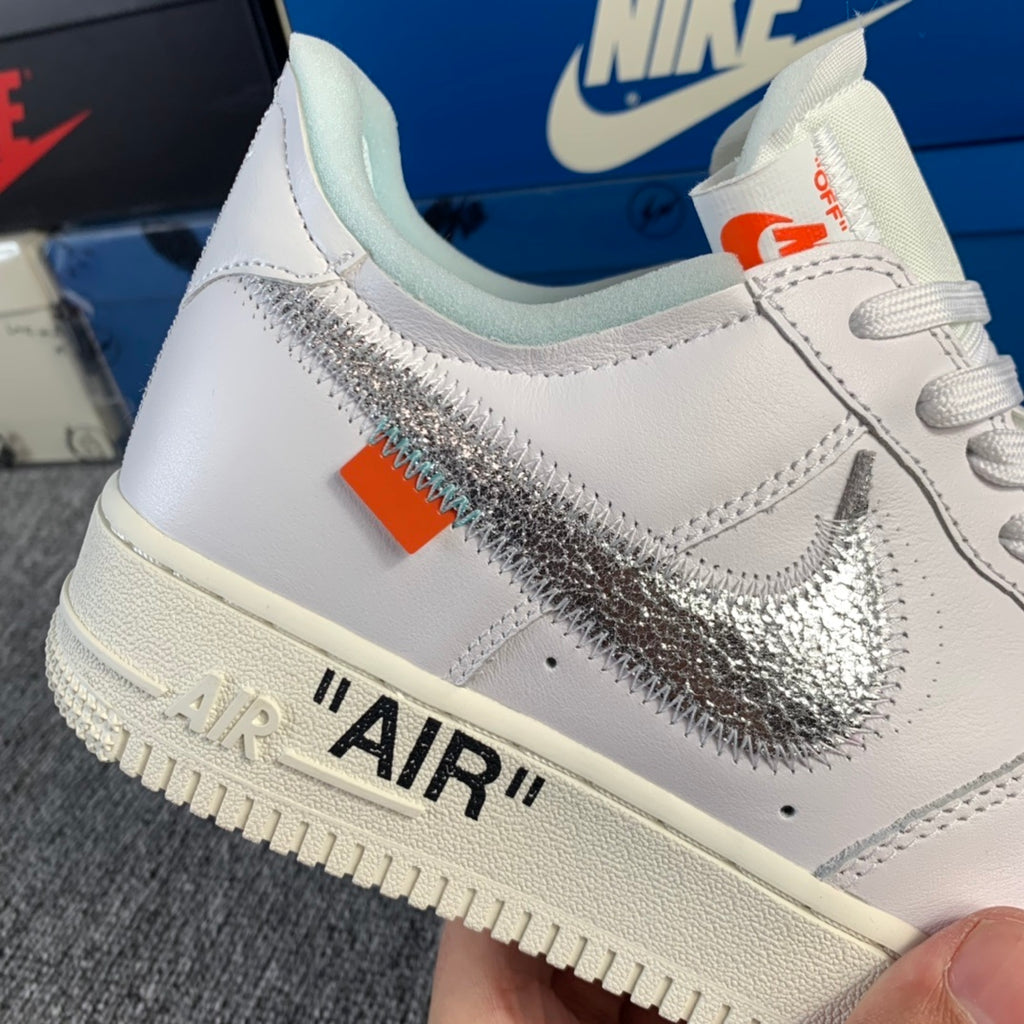 White low-top sneaker close-up with metallic silver swoosh and "AIR" branding