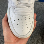 White sneaker toe box with lace-up eyelets and perforated ventilation holes