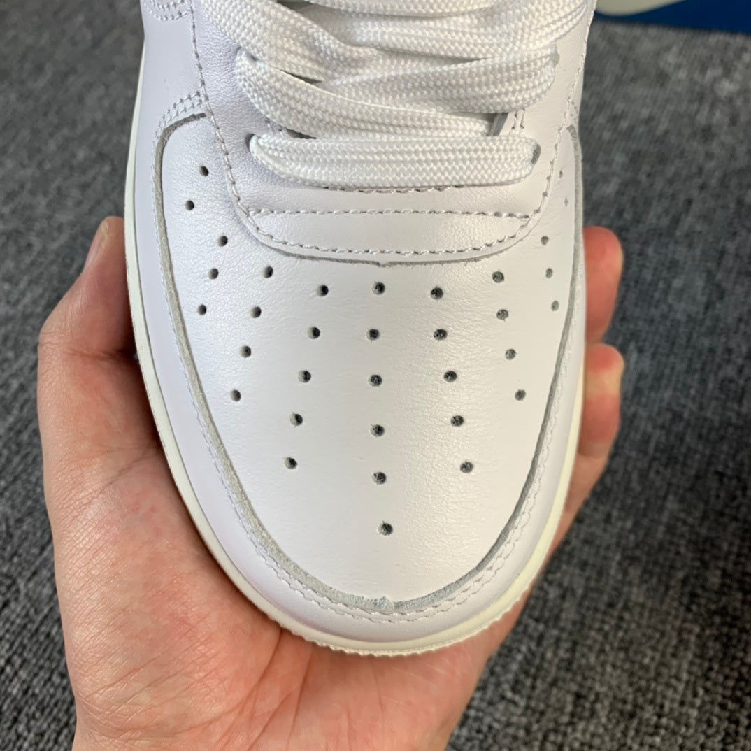 White sneaker toe box with lace-up eyelets and perforated ventilation holes