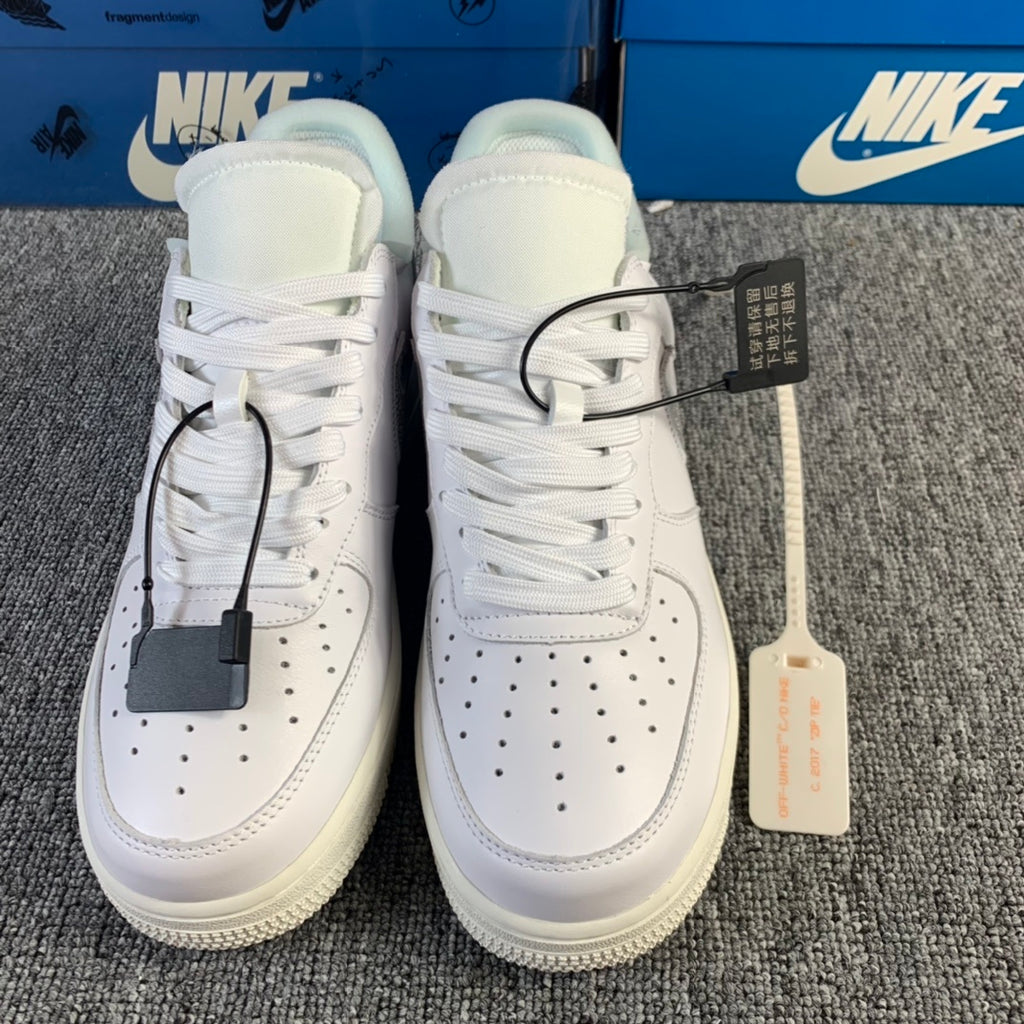 White low-top sneaker pair with white laces and hanging tags