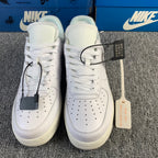 White low-top sneaker pair with white laces and hanging tags