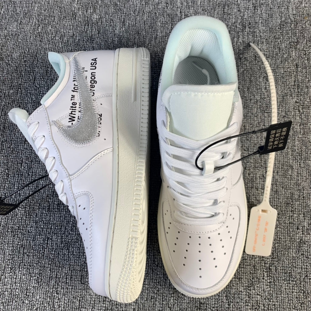 White low-top sneaker with side label text and gum-toned sole detail
