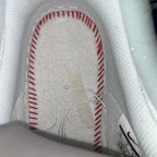 White sneaker interior lining with red-stitched seam details near the heel
