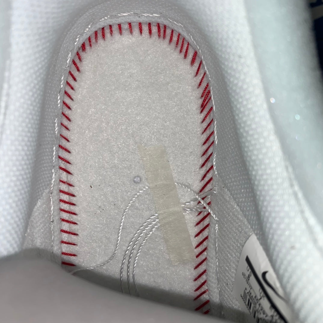 White sneaker interior lining with red-stitched seam details near the heel