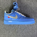 Blue low-top sneakers with swoosh, white laces, and AIR midsole text