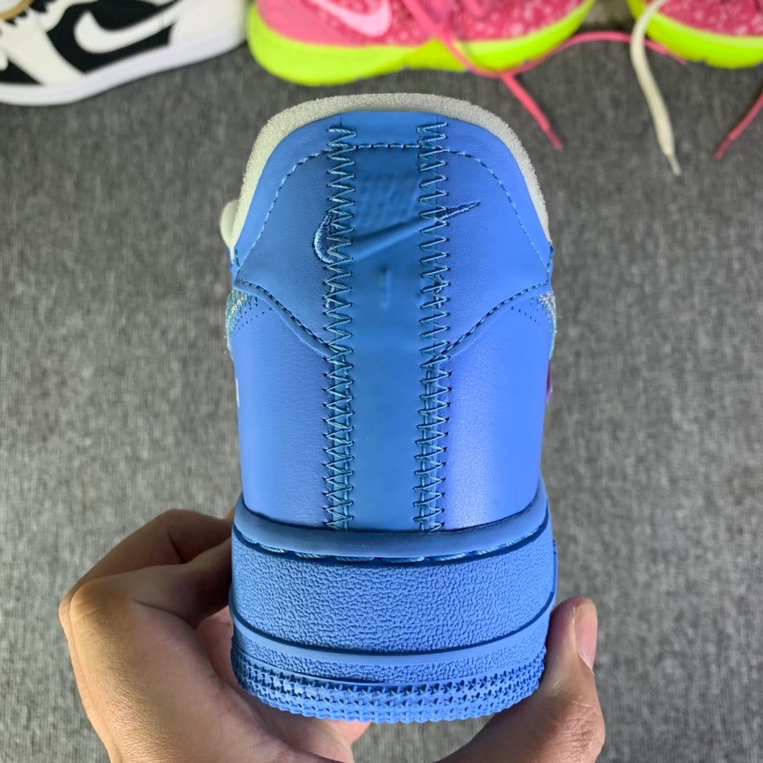Blue leather heel with stitched paneling and ridged sole, held in hand