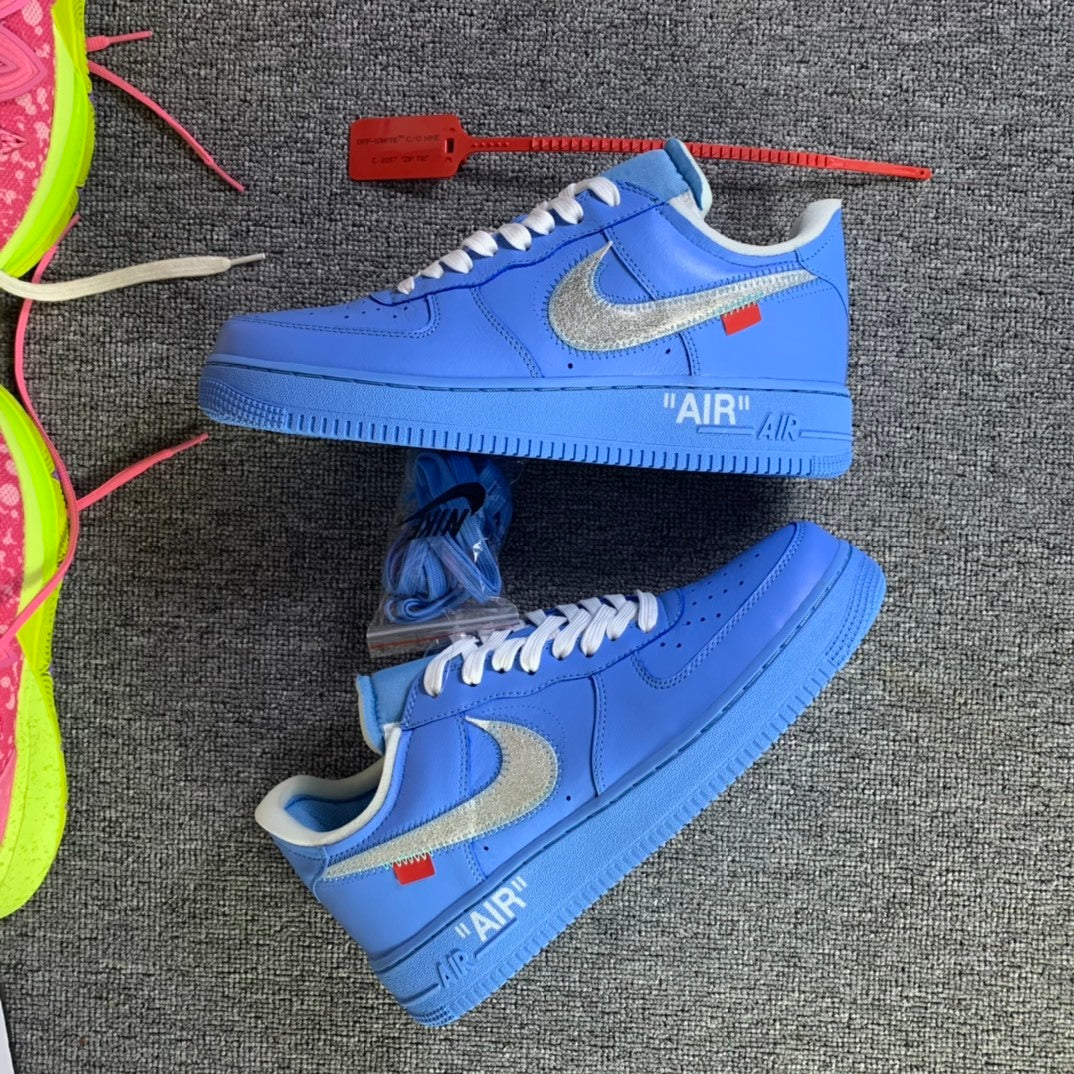 Pair of blue low-top sneakers with white laces and AIR text on midsoles