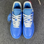 Blue low-top sneakers front view with white laces and perforated toe