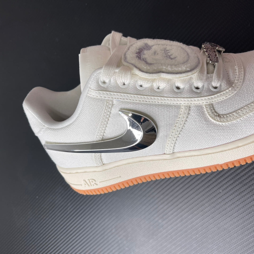 Low-top sneaker with sail upper, chrome heel logo, and orange gum sole