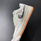 Low-top sneaker side view in sail with chrome swoosh and orange gum sole
