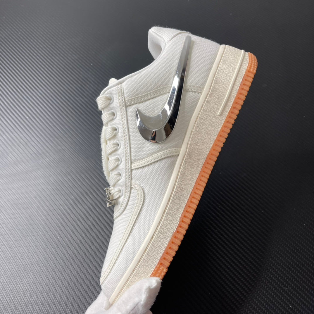 Low-top sneaker side view in sail with chrome swoosh and orange gum sole