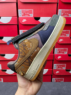 Low-top sneaker side view with olive suede, yellow logo patch, and dark laces
