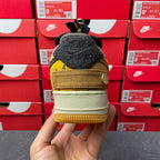 Low-top sneaker heel view with black heel tab, yellow accent stripe, and tan midsole