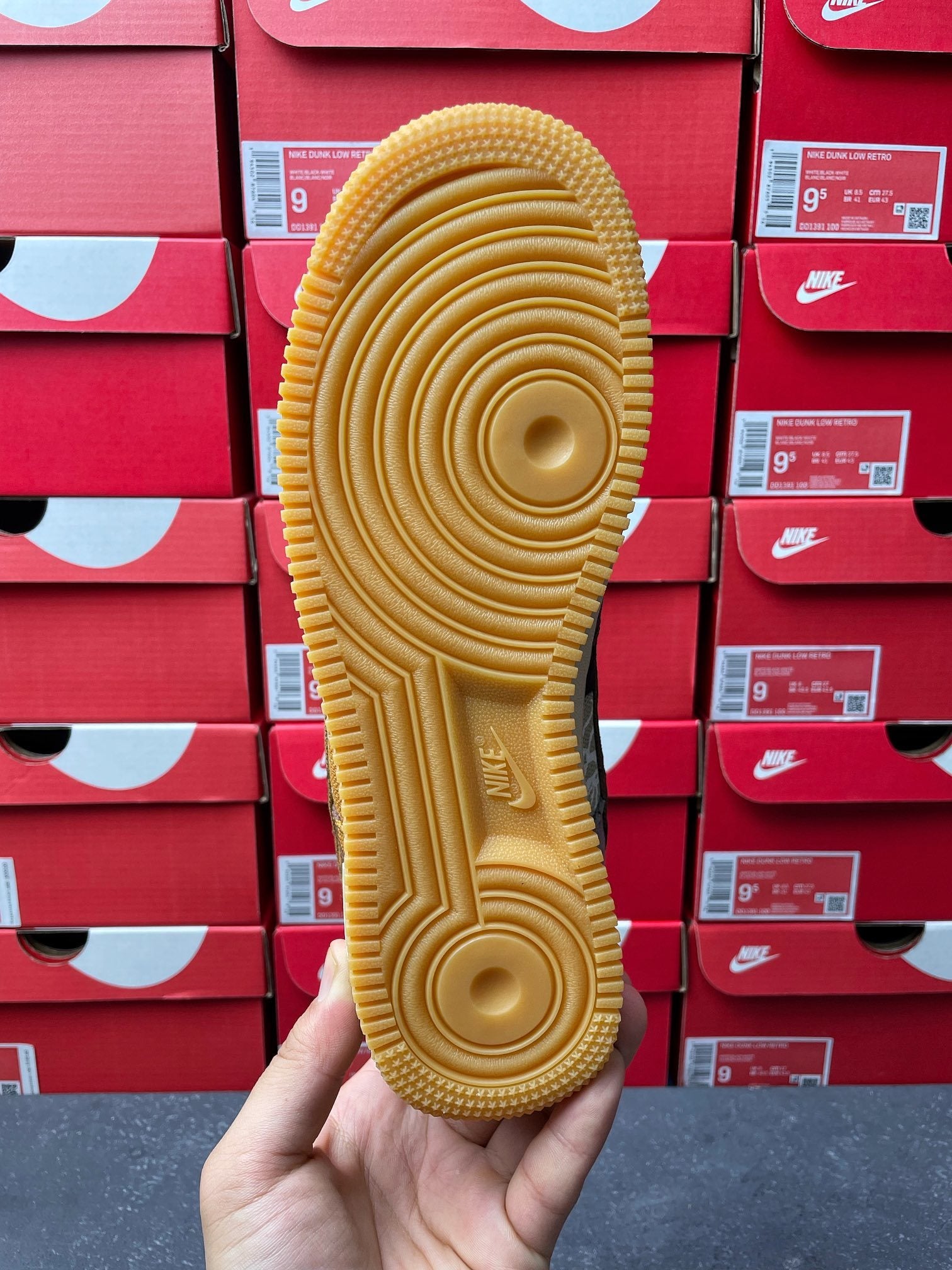 Gum-colored outsole with circular tread pattern and brand mark