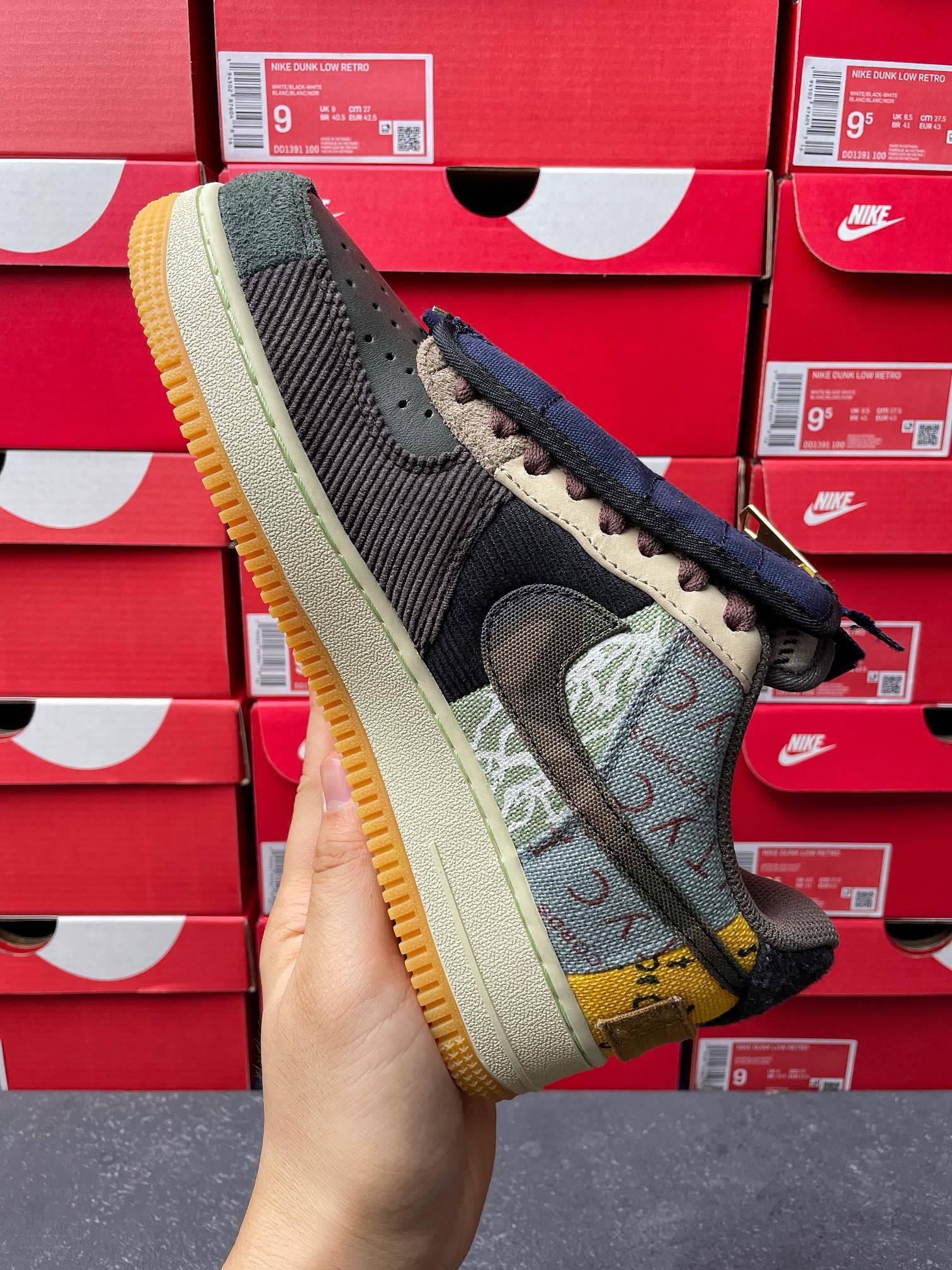 Low-top sneaker angled view with dark navy upper, camouflage swoosh, and gum outsole