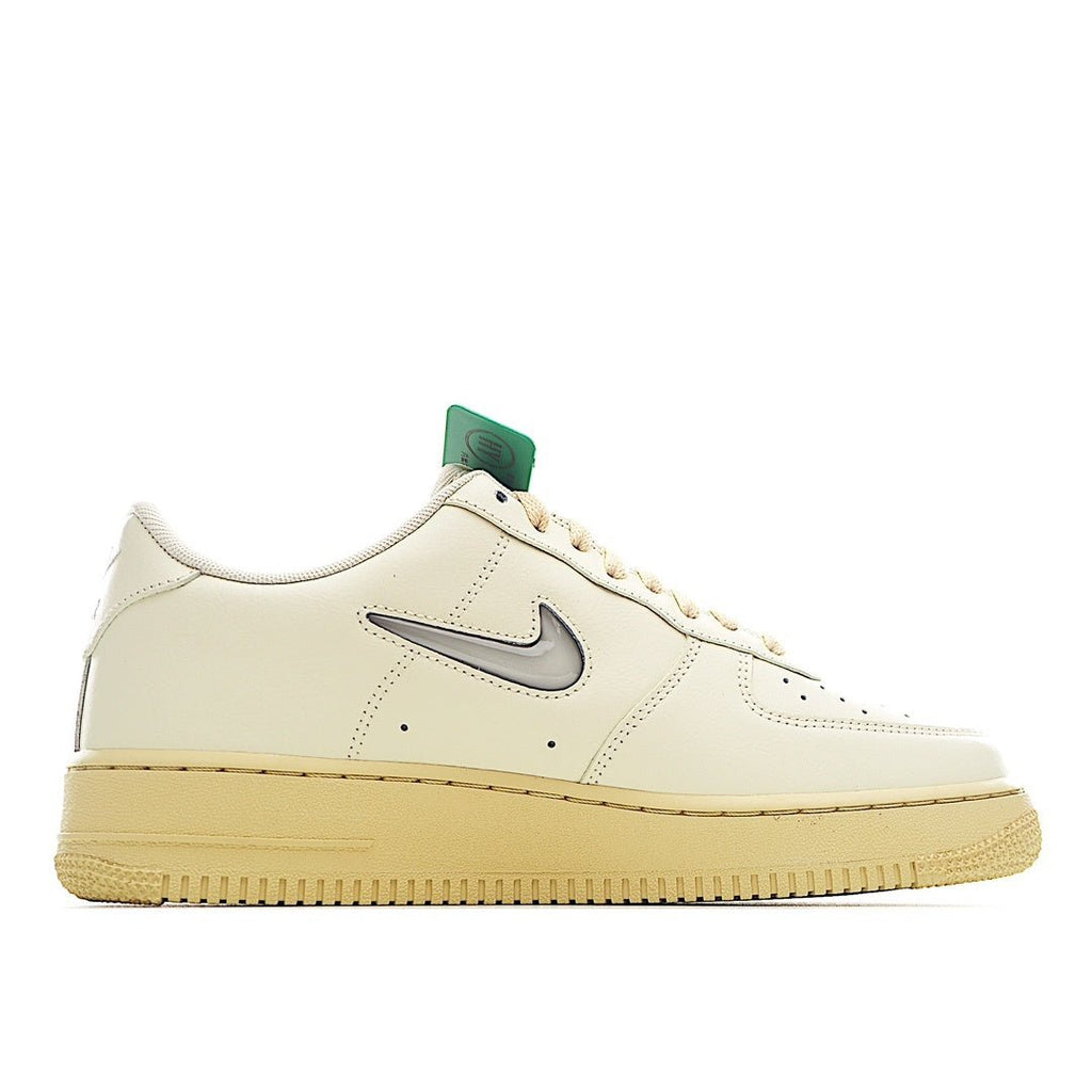 Nike Air Force 1 sneaker profile in light cream with black Swoosh and green lace detail