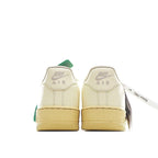 Nike Air Force 1 sneaker heel view in light cream with green pull tab