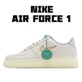 White low-top Nike Air Force 1 sneakers with green lace tag and side logo